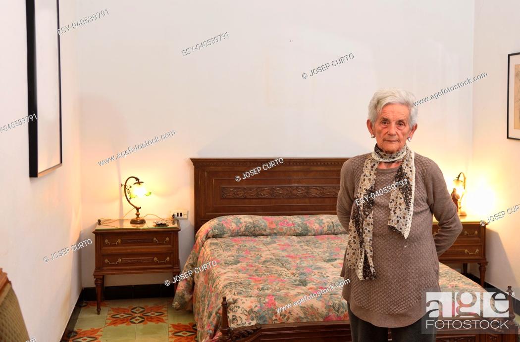 Stock Photo: portrait of an elderly woman in a bedroom.