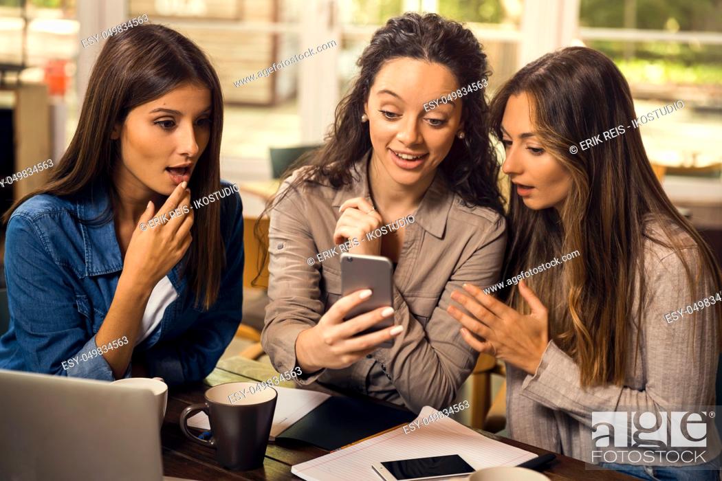 Stock Photo: Group of girls making a pause on the studies for some gossip.