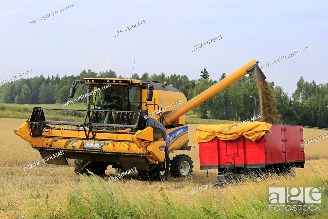 Stock Photo: Salo, Finland - July 29, 2018. Harvesting barley in Salo, Finland. Grain harvest begins in South of Finland with LUKE's forecast of the smallest crop in 21st.