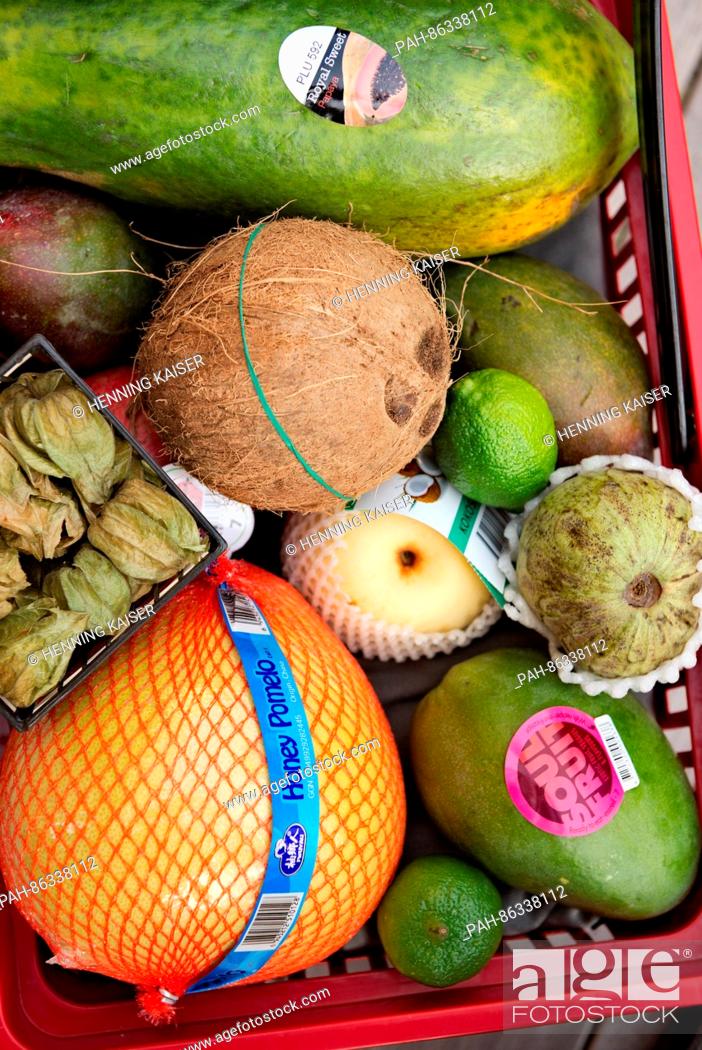 Stock Photo: A mango, nashi pear, physalis, pomelo, cherimoya, coconut and other varieties of exotic fruit seen in a shopping basket in Cologne, Germany, 07 December 2016.