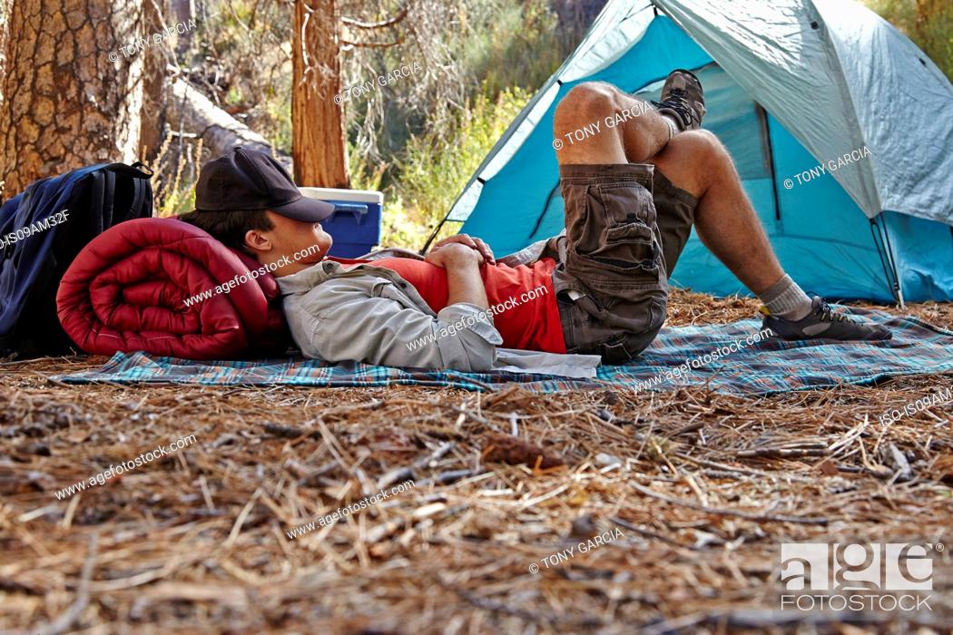 Stock Photo: Young male camper resting in forest, Los Angeles, California, USA.