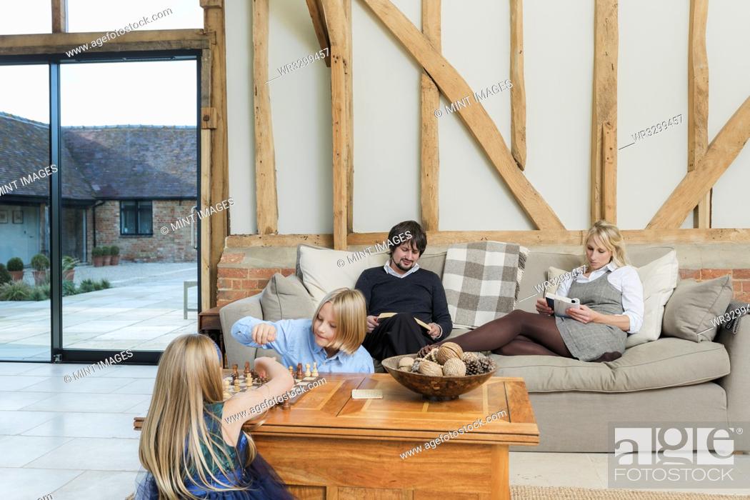 Stock Photo: Caucasian family relaxing in living room.