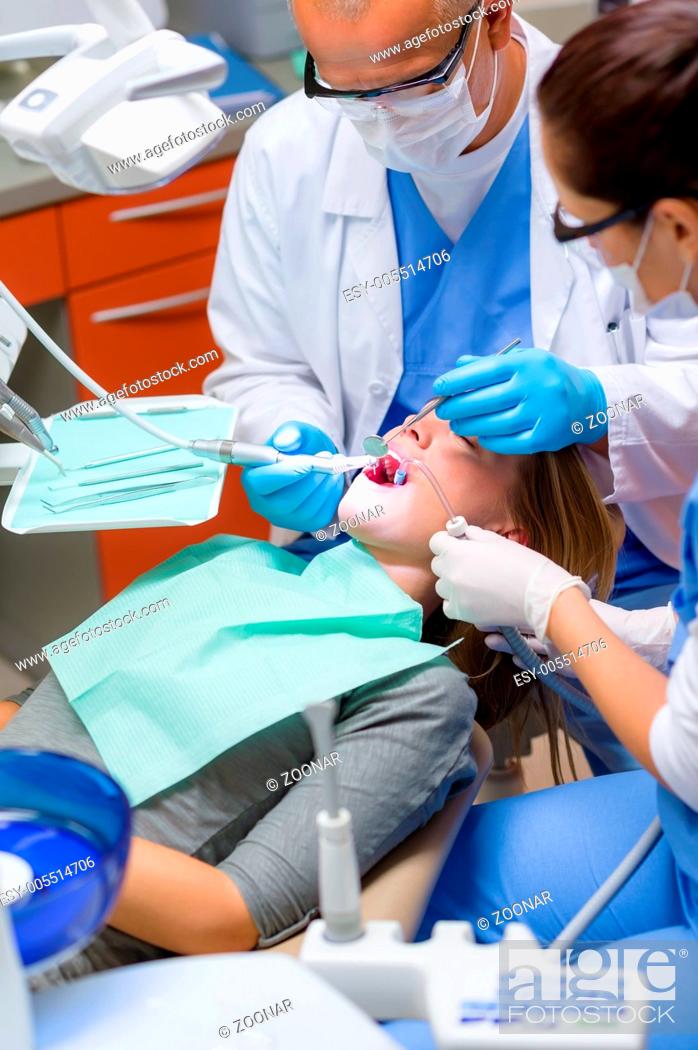 Stock Photo: Woman at dentist surgery have teeth treatment.