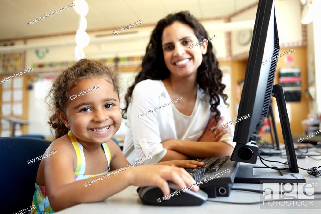 Stock Photo: Elementary School Pupil With Teacher In Computer Class.