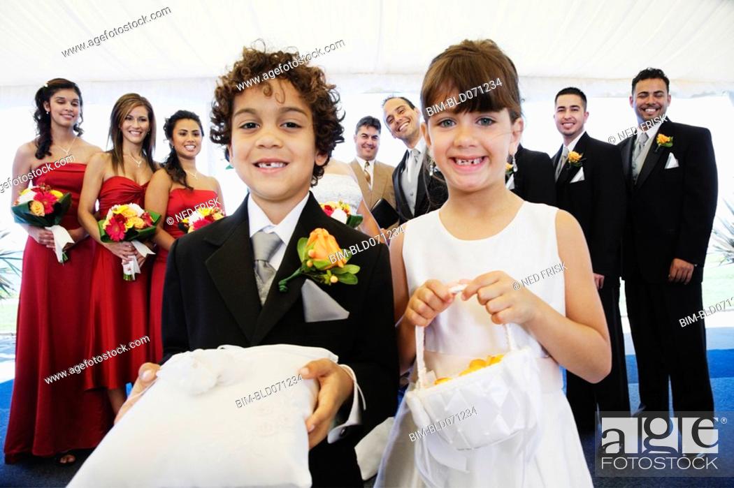 Stock Photo: Hispanic boy and girl as ring bearer and flower girl.