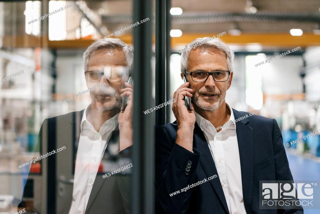 Stock Photo: Manager talking on the phone in high tech company.