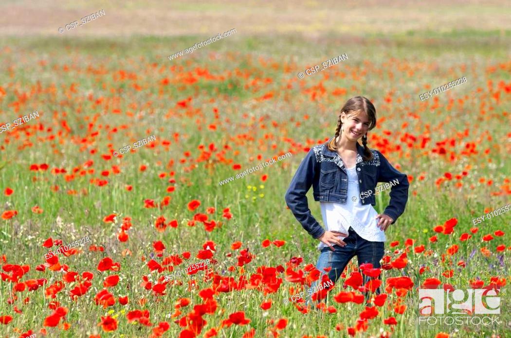 Stock Photo: Girl with poppies posing happily.