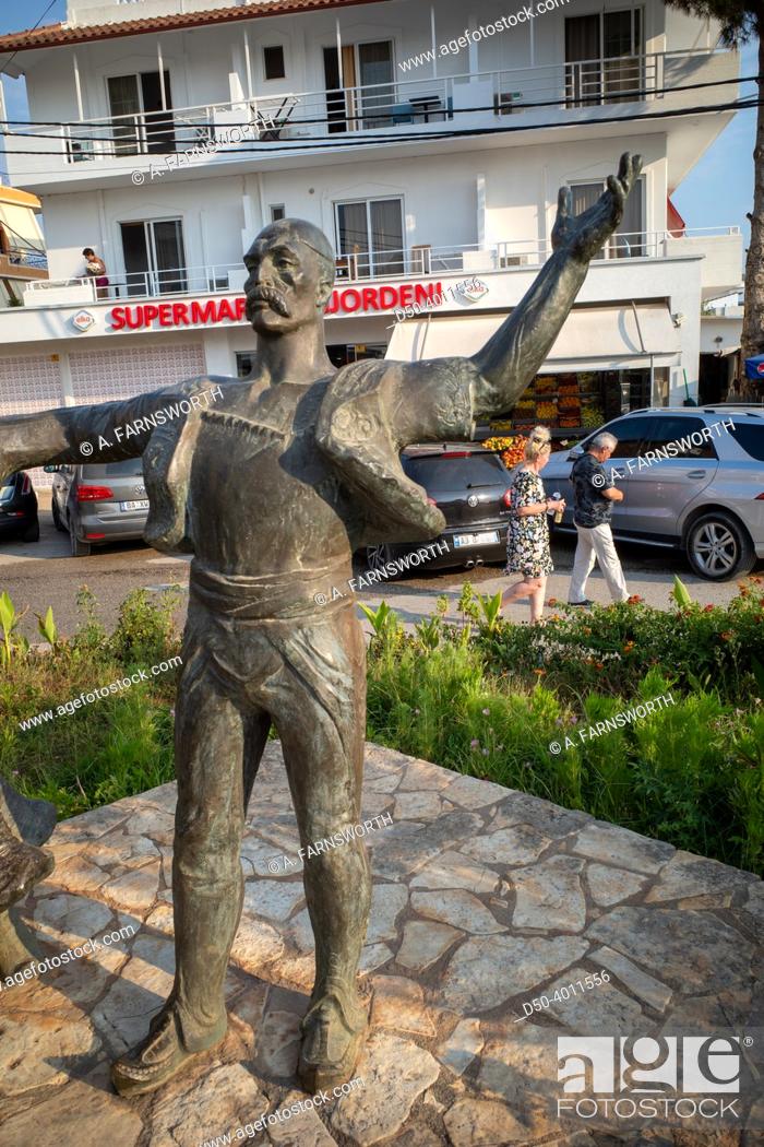 Stock Photo: Ksamil Albania Ksamil village center street, statue of dancing people in traditional clothing.