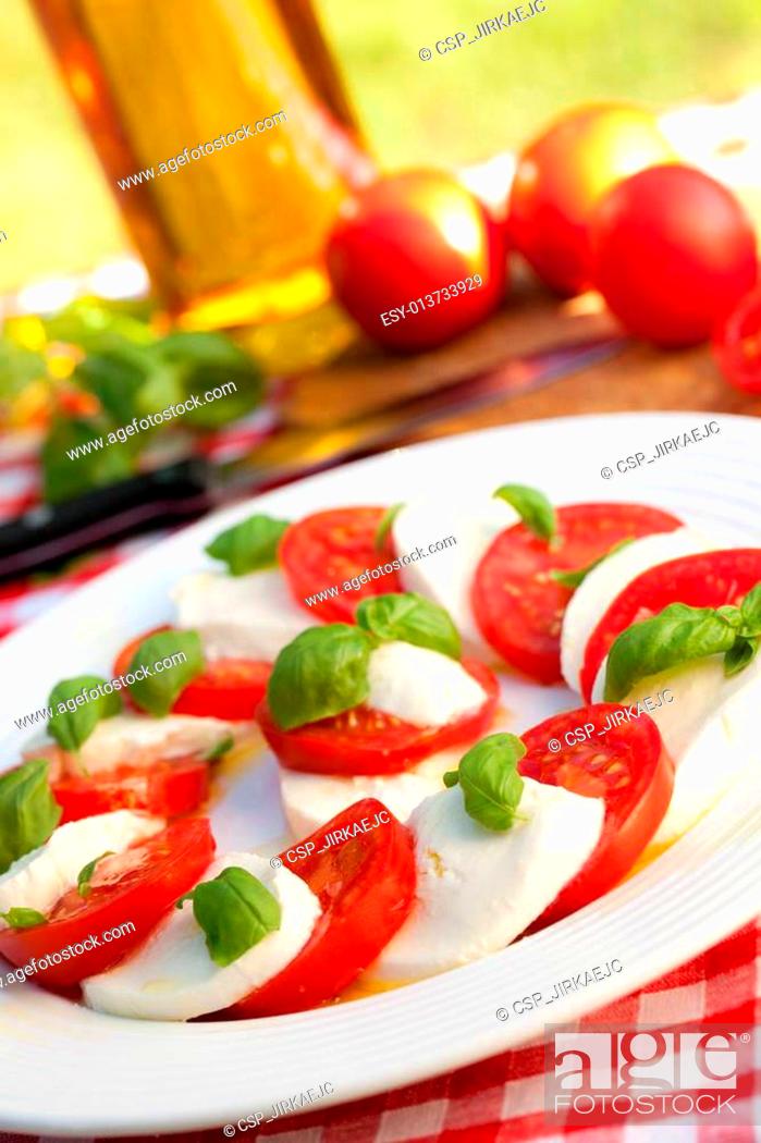 Stock Photo: caprese salad on white plate.