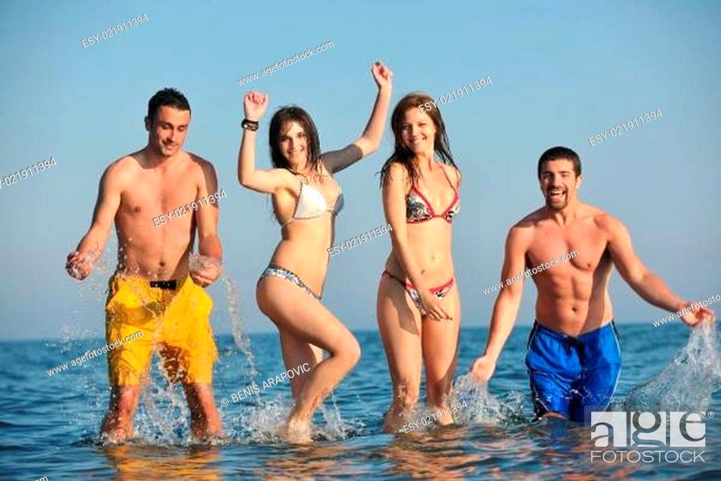 Stock Photo: happy people group have fun and running on beach.