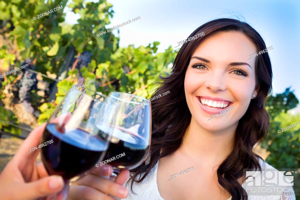 Stock Photo: Pretty Mixed Race Young Adult Woman Enjoying A Glass of Wine in the Vineyard with Friends.