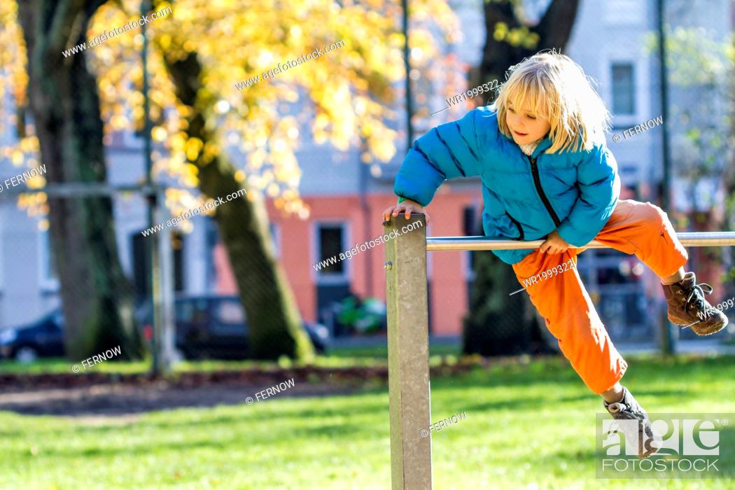 Stock Photo: Close-Up, Color Image, One, Outdoors, People, Sport, Leisure, Horizontal, Child, Kid, Childhood, Girl, Bar, Blond, Playing, Blue, Object, Head, Photography, Europe, Germany, Haired, Hair, Equipment, Year, Jacket, Top, Bright, High, Focus
