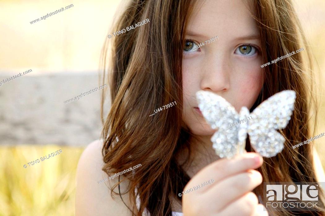 Stock Photo: Mystery girl showing her butterfly.