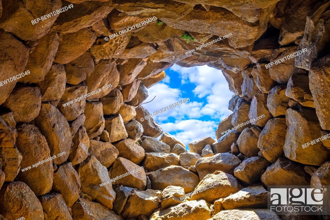 Stock Photo: Arzachena, Sardinia / Italy - 2019/07/19: Archeological ruins of Nuragic complex La Prisgiona - Nuraghe La Prisgiona - with interior of stone tower of Neolithic.