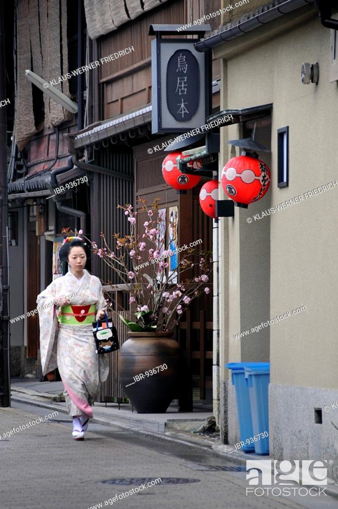 Stock Photo: Maiko, Geisha apprentice, in the Gion quarter in Kyoto walking to Odori performance, Japan, Asia.