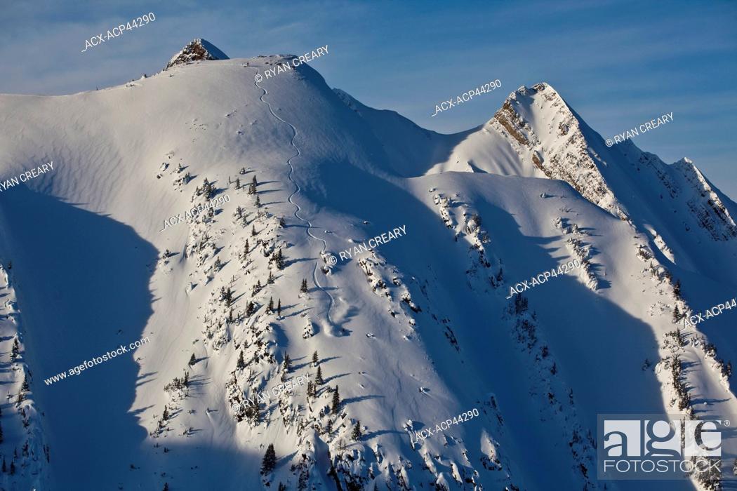 Stock Photo: A backcountry snowboarder rides a steep line in the Kicking Horse Backcountry, Golden, Britsh Columbia, Canada.