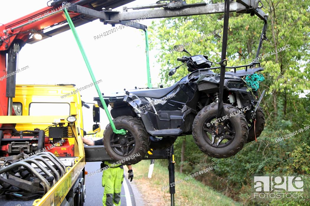Stock Photo: 01 September 2022, Bavaria, Johannesberg: A crashed quad bike hangs from the crane of a tow truck after a traffic accident in Johannesberg.