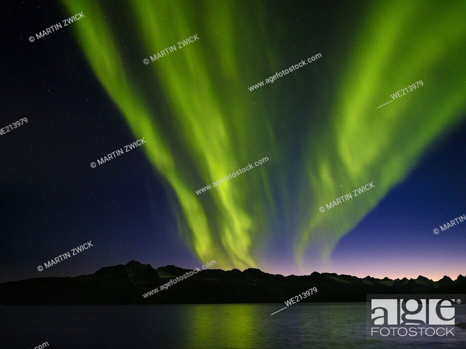 Stock Photo: Northern lights over Angmagssalik Fjord near settlement Kuummiit (formerly spelled Kummiut). Ammassalik area in East Greenland.