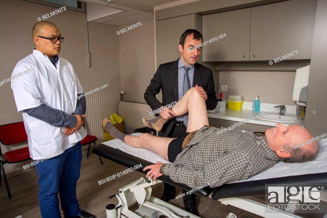 Stock Photo: Reportage in Nollet Clinic in Paris, France. Post-op consultation (hip replacement) with Dr Nogier, a hip surgeon. Looking for pain when the hip is flexed.