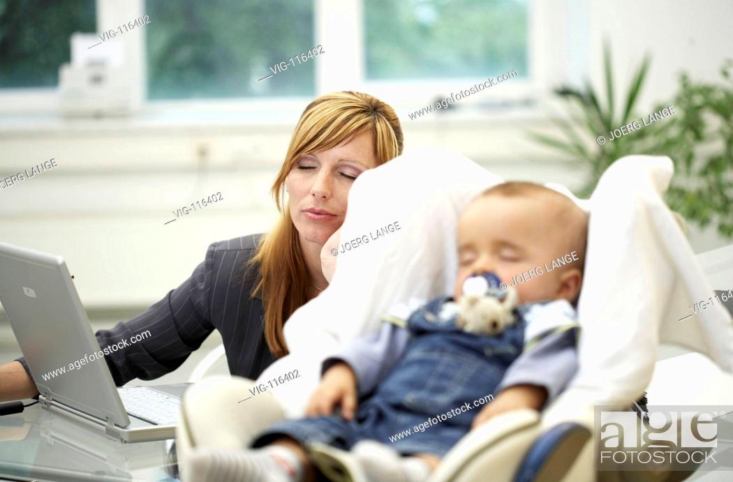 Stock Photo: A business woman falls to sleep in her bureau. She is exhausted by doing both work and care for her baby. - DRESDEN, GERMANY, 23/08/2005.