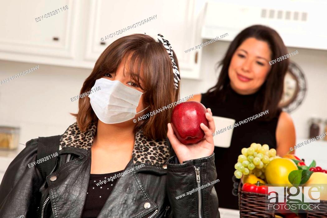 Stock Photo: Young Hispanic Girl Student with Mother At Home Getting Ready For School Wearing Medical Face Mask.