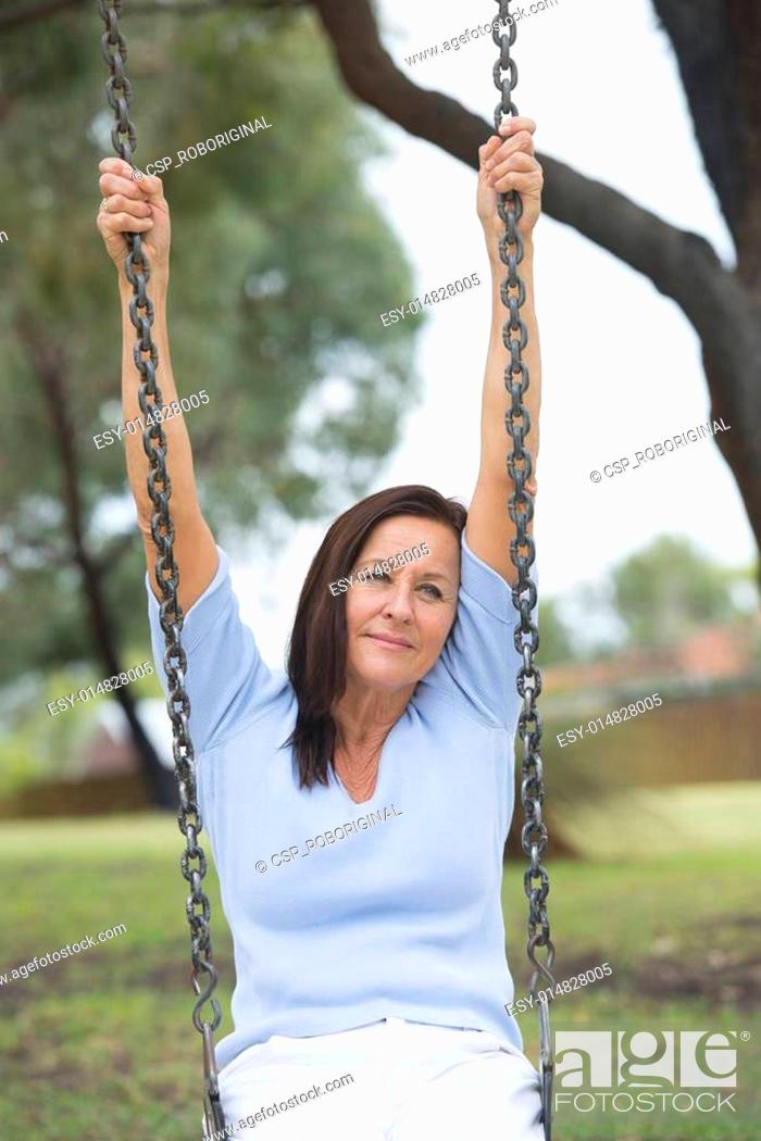Happy Relaxed Mature Woman On Swing Outdoor Stock Photo Picture