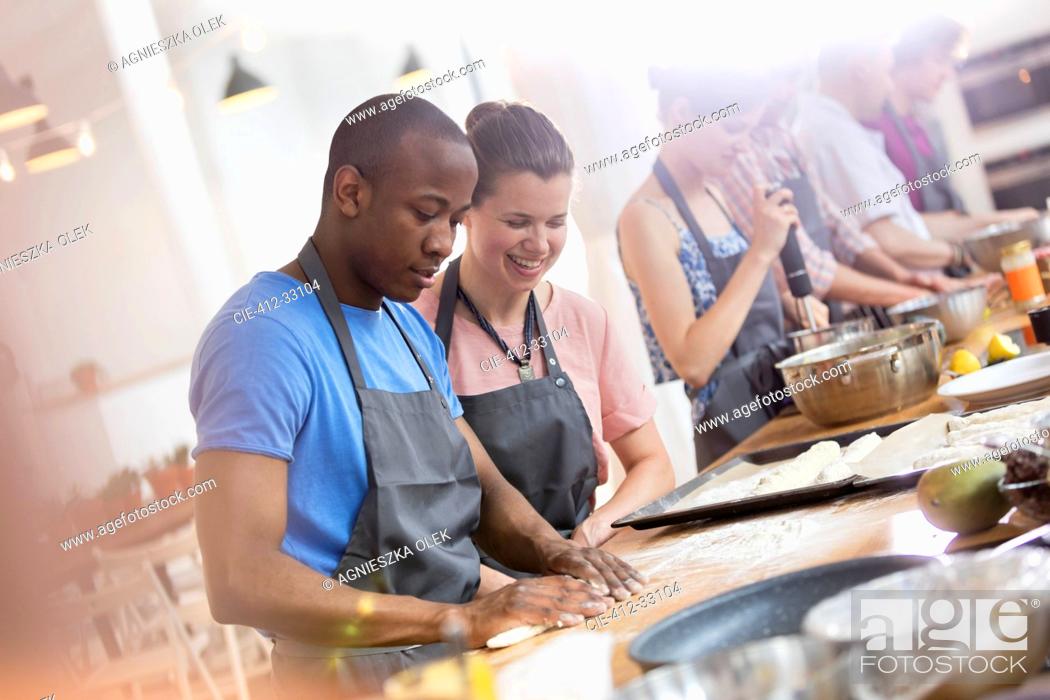 Stock Photo: Couple enjoying cooking class in kitchen.