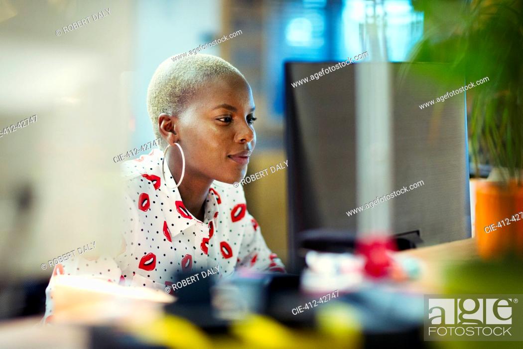Stock Photo: Focused businesswoman working at computer in office.