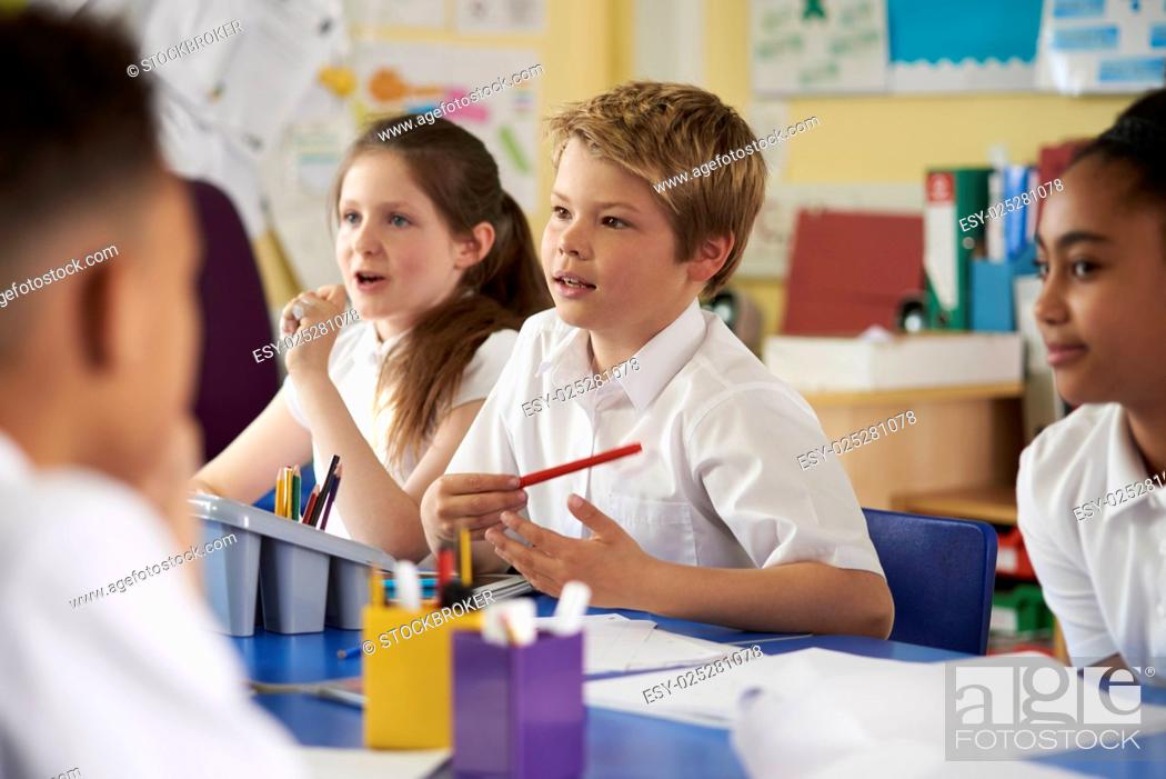 Stock Photo: Primary school children work together in class, close up.