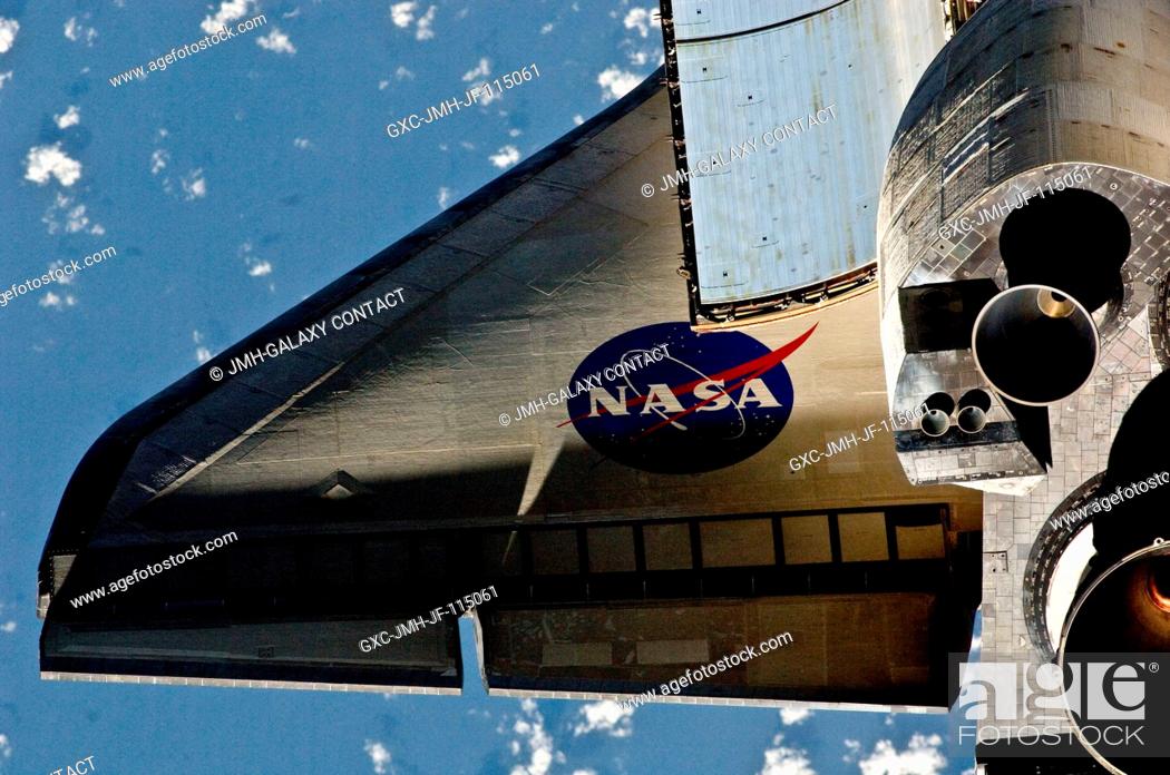 Stock Photo: This partial view of the port wing of the space shuttle Discovery was provided by an Expedition 26 crew member during a survey of the approaching STS-133.