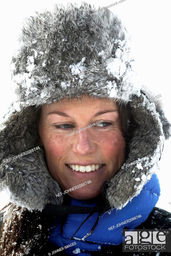 Stock Photo: Woman in a snowy fur cap.