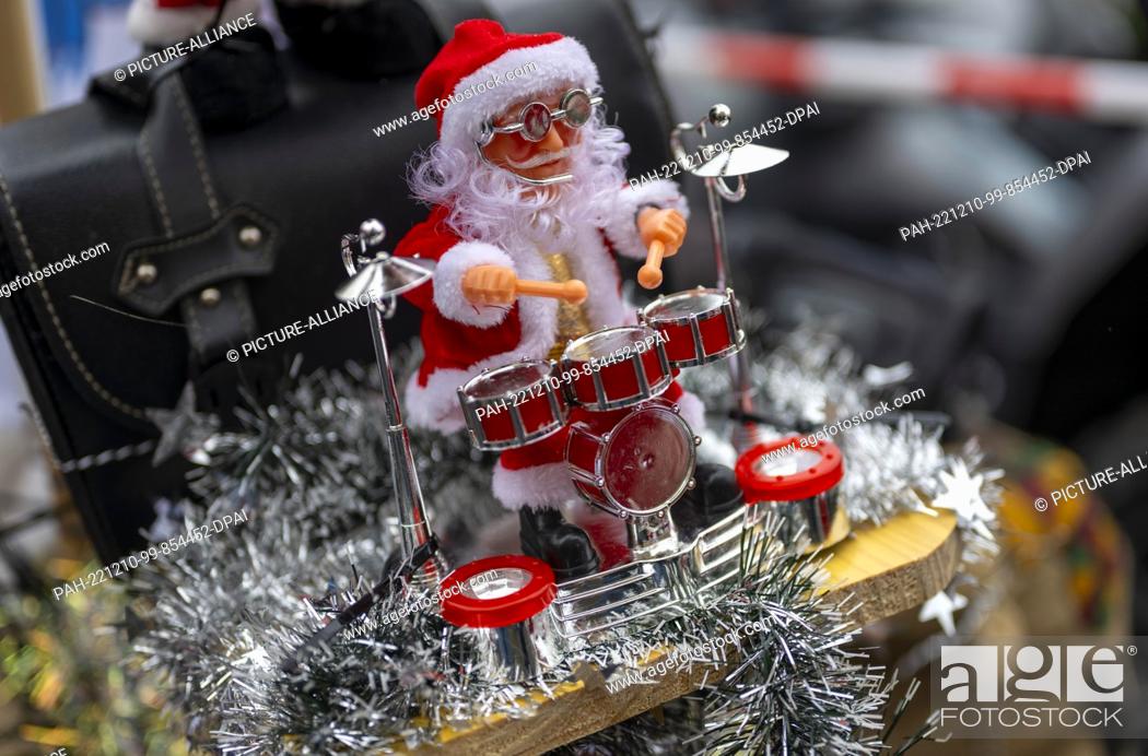 Stock Photo: 10 December 2022, Berlin: A figure of Santa Claus with drums is mounted on a Christmas-decorated motorcycle in the ""Santa Claus on Road"" campaign.