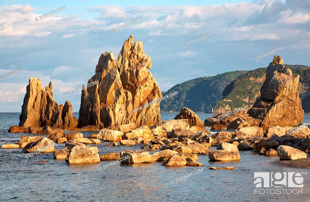 Stock Photo: Hashigui-iwa (Bridge Pillar Rocks) - the series of rocks leading towards Oshima Island near Kushimoto at the sunset light. Wakayama prefecture. Honshu.
