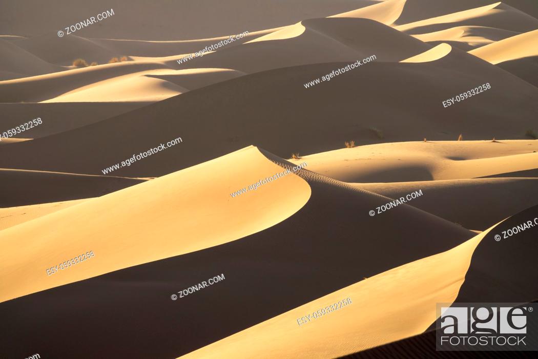 Stock Photo: Background with beautiful structures of sandy dunes at sunrise in the Sahara desert.