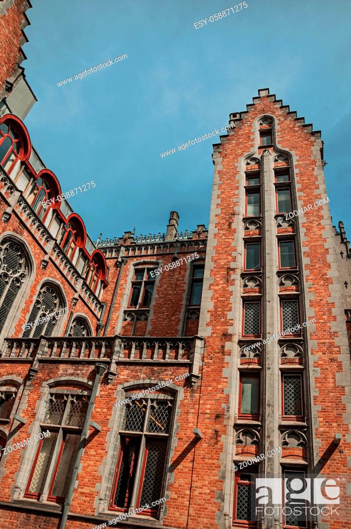 Stock Photo: Brick facade of buildings in typical Flanders style and blue sky at Bruges. With many canals and old buildings, this graceful town is a World Heritage Site of.