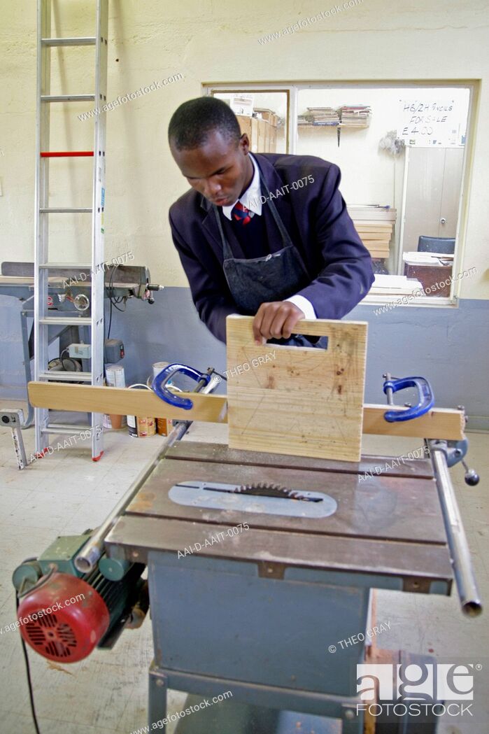 Stock Photo: School boy using cut saw in woodwork classroom, St Mark's School, Mbabane, Hhohho, Kingdom of Swaziland.
