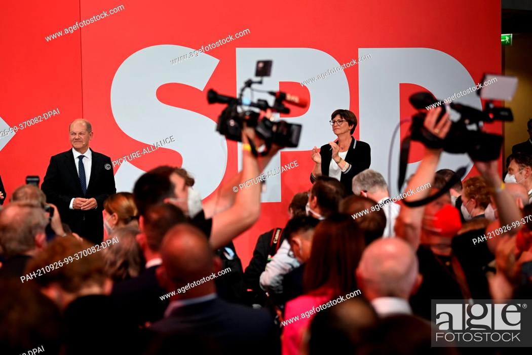 Stock Photo: 26 September 2021, Berlin: Olaf Scholz, Finance Minister and SPD candidate for Chancellor, stands with SPD party chairwoman Saskia Esken during the election.