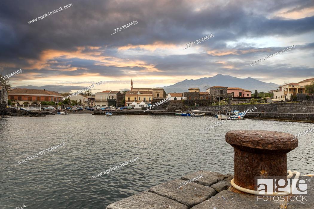 Stock Photo: View of a small Sicilian fishing port. In the background stands the Etna volcano.
