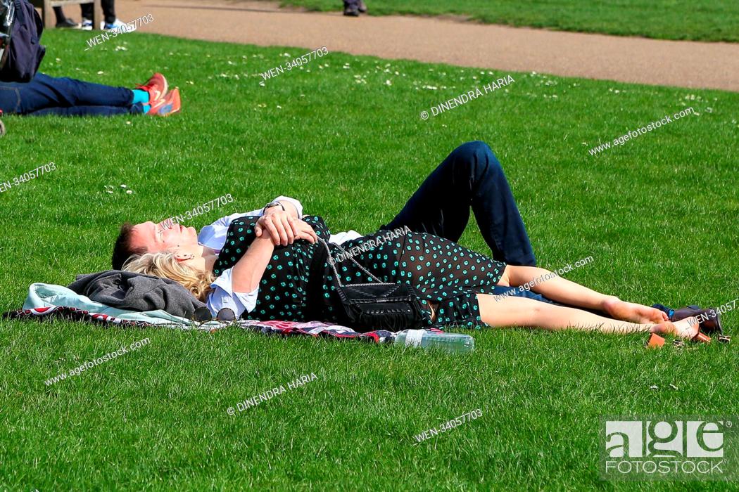 Stock Photo: Tourists and Londoners enjoy warm spring sunshine in St James Park in Westminster as higher temperatures are forecast across the UK in coming week.