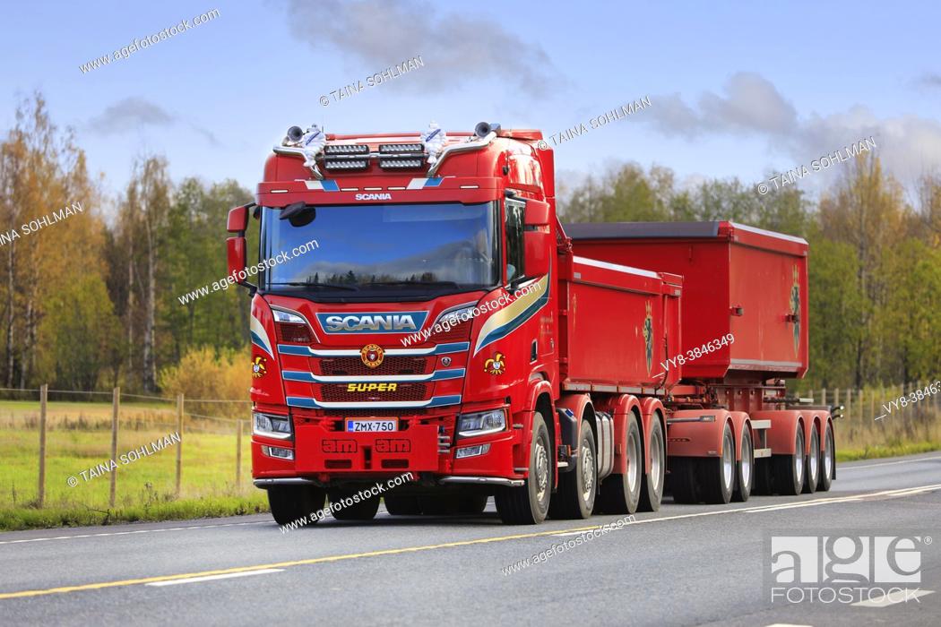 Stock Photo: Red customised Scania R of Kuljetus Timo Šberg Oy pulls gravel trailer along highway 2 on a day of autumn. Tammela, Finland. October 16, 2020.