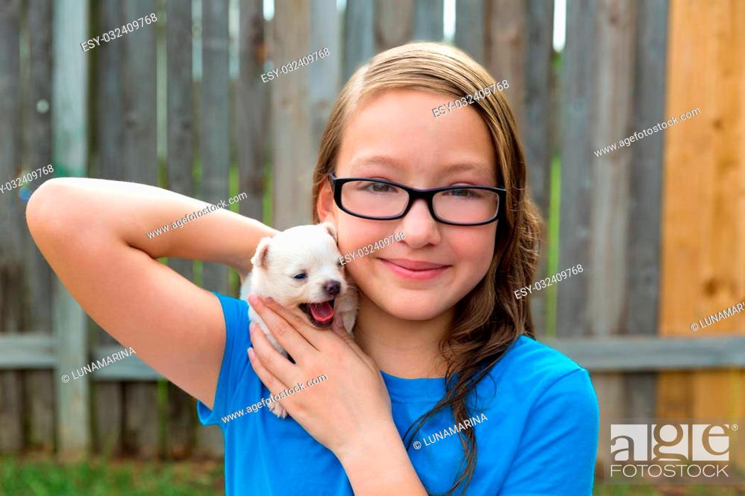 Stock Photo: kid girl with puppy pet chihuahua playing happy with doggy outdoor.