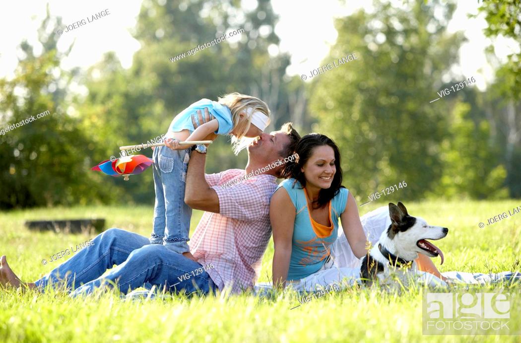 Stock Photo: A young family seeking relaxation in a park.  - Dresden, GERMANY, 05/09/2005.