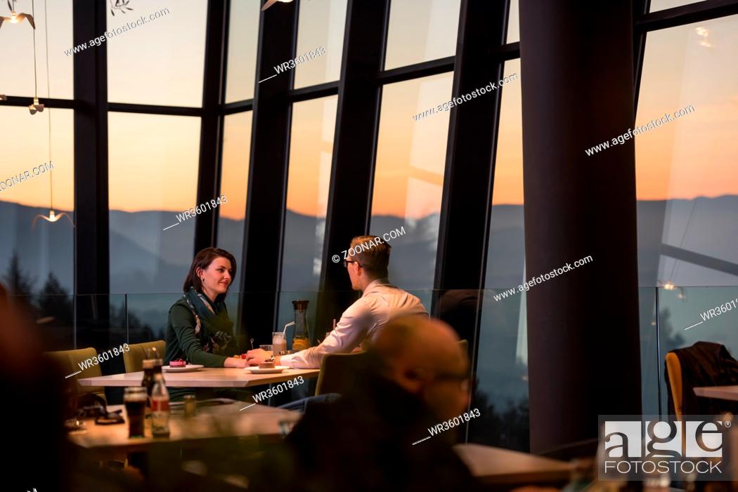 Stock Photo: Couple celebrate Valentine's day with romantic dinner in restaurant near the window.