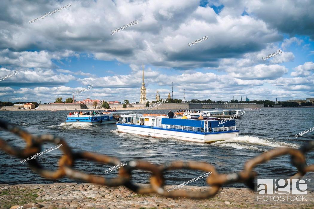 Stock Photo: pleasure boat and the peter and paul fortress in background, st. petersburg, russia.