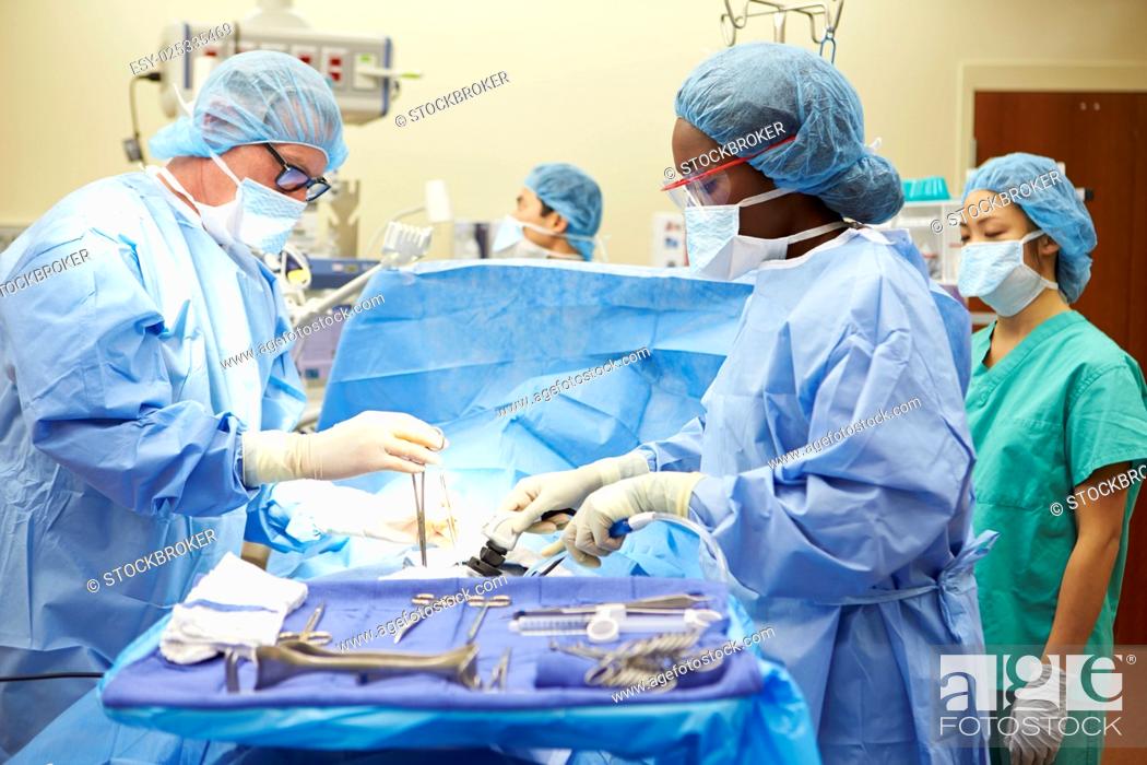 Stock Photo: Surgical Team Working In Operating Theatre.