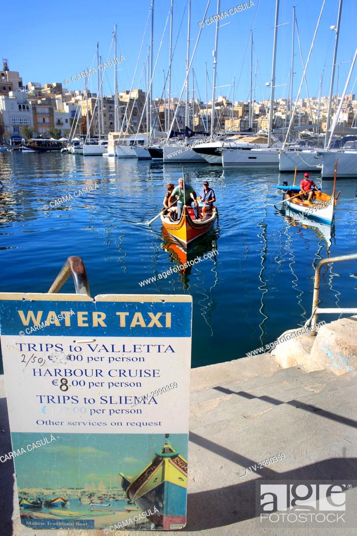 Stock Photo: gondolas and taxi boats in the canal of Birgu, Three Cities. Valletta, Malta.