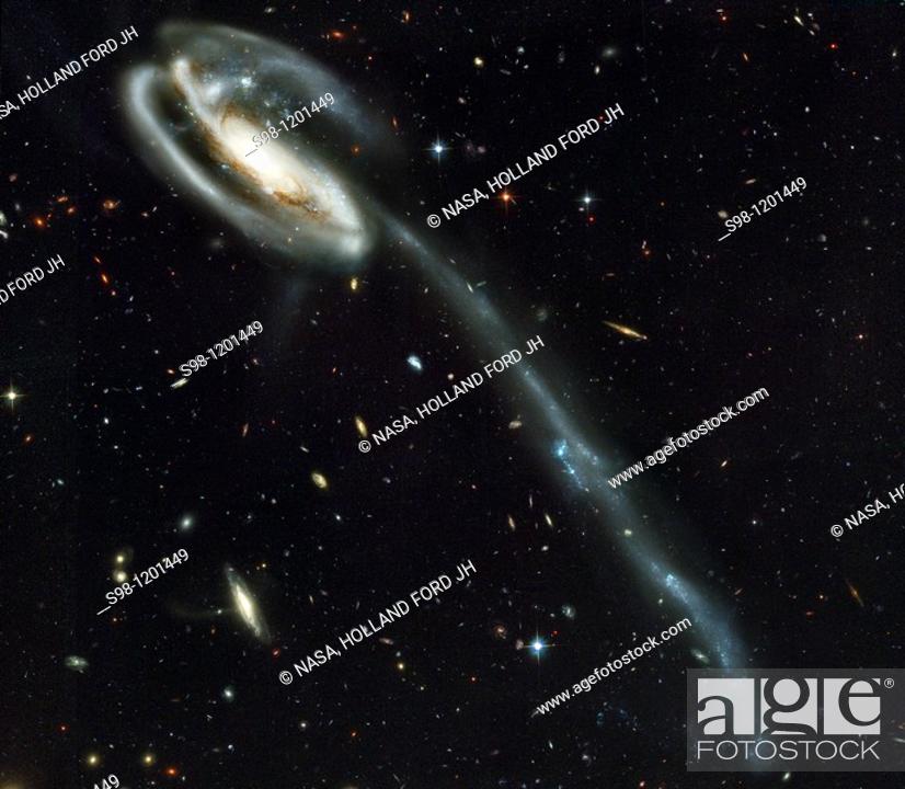 Stock Photo: A 'wallpaper' of distant galaxies is a stunning backdrop for a runaway galaxy  Against a stunning backdrop of thousands of galaxies.