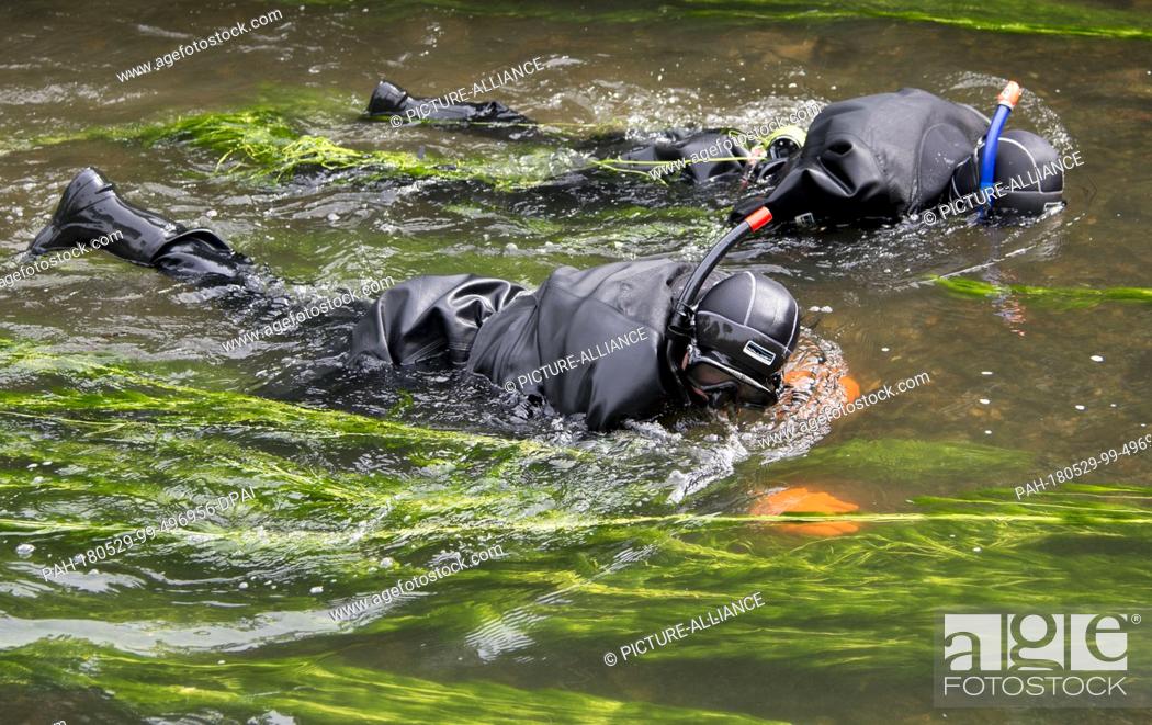 Stock Photo: 29 May 2018, Germany, Offenburg: Task forces of the water police searching the Muehlbach river near the university of applied sciences in Offenburg as part of.