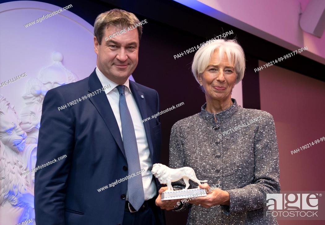 Stock Photo: 14 February 2019, Bavaria, München: Markus Söder (CSU), Prime Minister of Bavaria, hands over a Bavarian lion to Christine Lagarde.