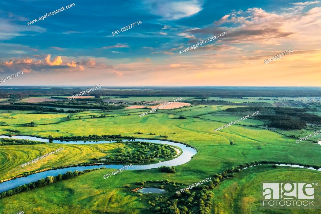 Stock Photo: Aerial View. Sunny Sky Above Green Forest, Meadow And River Landscape In Sunny Evening. Top View Of European Nature From High Attitude In Summer Sunrise.